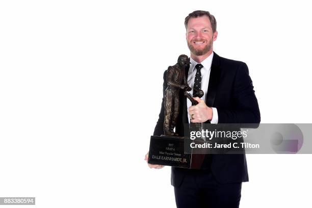 Driver Dale Earnhardt Jr. Poses with NASCAR most popular driver award following the Monster Energy NASCAR Cup Series awards at Wynn Las Vegas on...