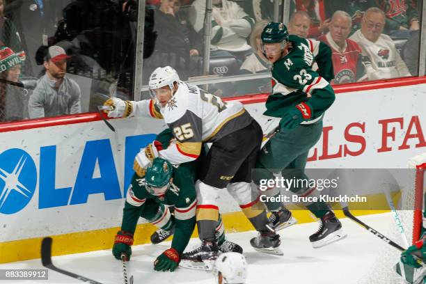 Mike Reilly and Gustav Olofsson of the Minnesota Wild defend Stefan Matteau of the Vegas Golden Knights during the game at the Xcel Energy Center on...