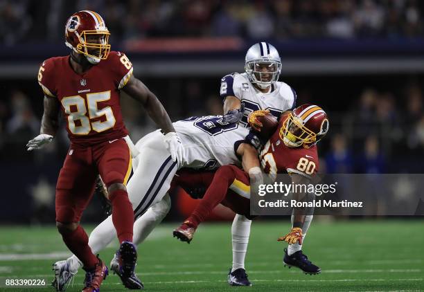 Jamison Crowder of the Washington Redskins is tackled by Jeff Heath of the Dallas Cowboys in the second quarter at AT&T Stadium on November 30, 2017...