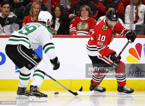Patrick Sharp of the Chicago Blackhawks moves to the puck under pressure from Greg Pateryn of the Dallas Stars at the United Center on November 30,...