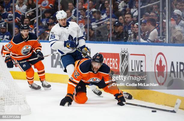 Eric Gryba of the Edmonton Oilers defends the zone against Matt Martin of the Toronto Maple Leafs at Rogers Place on November 30, 2017 in Edmonton,...