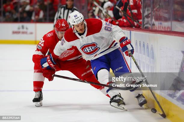 Andrew Shaw of the Montreal Canadiens battles to control the puck in front of Xavier Ouellet of the Detroit Red Wings during the third period at...