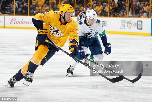 Anthony Bitetto of the Nashville Predators skates against Markus Granlund of the Vancouver Canucks during an NHL game at Bridgestone Arena on...