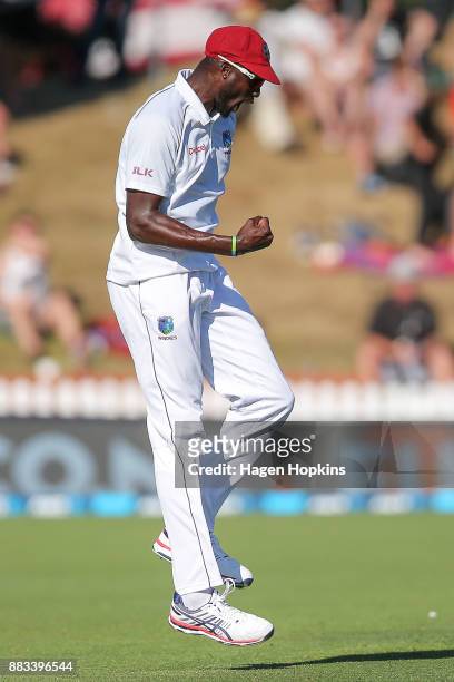 Jason Holder of the West Indies celebrates the wicket of Kane Williamson of New Zealand during day one of the Test match series between the New...