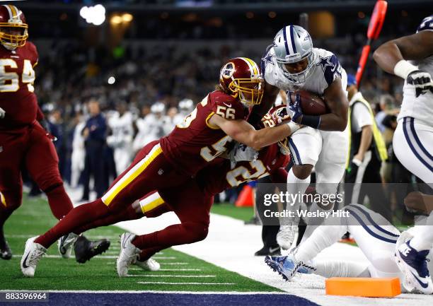 Zach Vigil of the Washington Redskins forces Rod Smith of the Dallas Cowboys out of bounds short of the goal in the fourth quarter of a football game...
