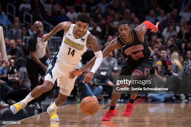 Gary Harris of the Denver Nuggets and Kris Dunn of the Chicago Bulls battle for the basketball at Pepsi Center on November 30, 2017 in Denver,...