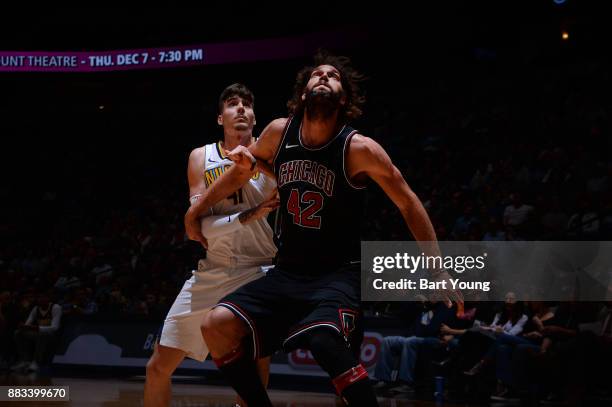 Robin Lopez of the Chicago Bulls boxes out against Juan Hernangomez of the Denver Nuggets on November 30, 2017 at the Pepsi Center in Denver,...