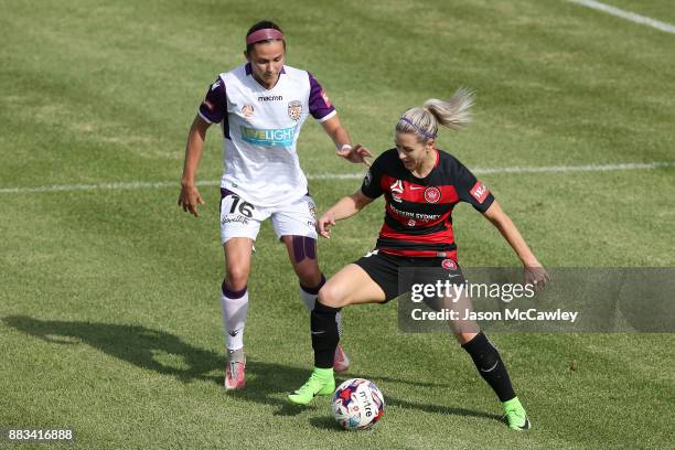 Erica Halloway of the Wanderers is challenged by Amanda Frisbie of the Glory during the round six W-League match between the Western Sydney Wanderers...