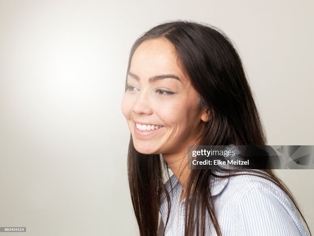 Smiling Knowingly Young Woman Smiling Knowingly High-Res Stock Photo - Getty Images