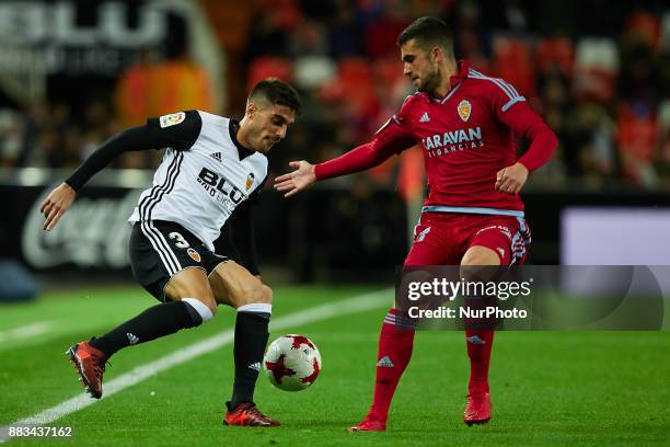 Nacho Vidal of Valencia CF competes for the ball with Alain of Real Zaragoza during the Copa del Rey round of 32 second leg match between Valencia CF...