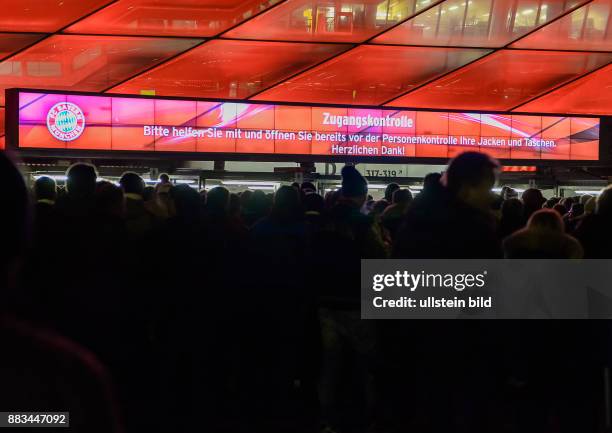 Eine Leuchtreklame weisst auf die Sicherheitskontrollen hin. Lange Schlangen bilden sich vor dem Stadion da die Sicherheitskontrollen ausgiebig sind...