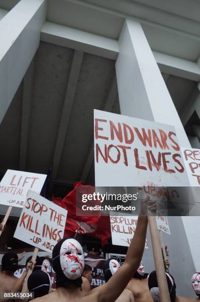 Members of the Alpha Phi Omega display placards as they run around naked in the Arts and Sciences building in the traditional &quot;Oblation...