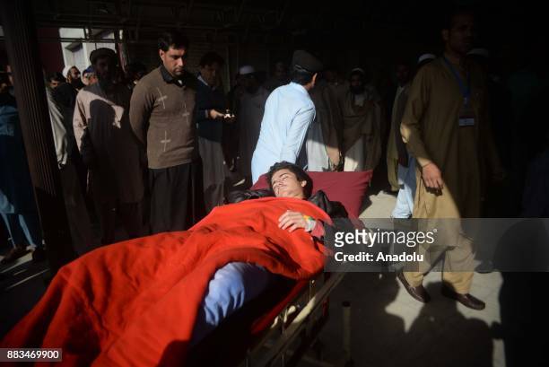 Pakistani injured victim is being carried on a stretcher at a hospital following an attack on Peshawar Agricultural Training Institute by Taliban...