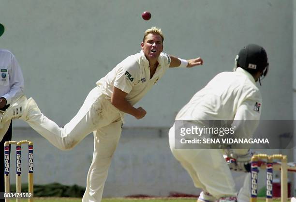 Australian spring bowler Shane Warne delivers a ball against Pakistani batsman Rashid Latif during the third day of the first cricket test match...