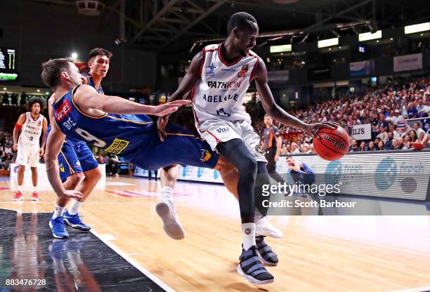 Majok Deng of the 36ers drives to the basket as Shaun Bruce of the Bullets defends during the round eight NBL match between the Adelaide 36ers and...