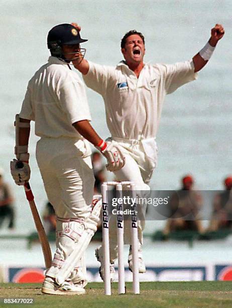 New Zealand bowler Chris Cairns celebrates after the dismissal of India's Rahul Dravid, who was caught out by Nathan Astle for 1, during the first...