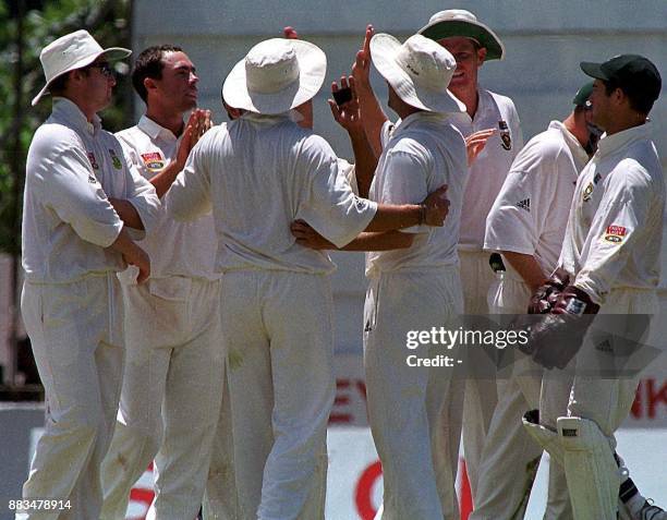 South African bowler Nicky Boje celebrates the dismissal of Sri Lankan batsman Mahela Jayewardene with teammats during the third and final test...