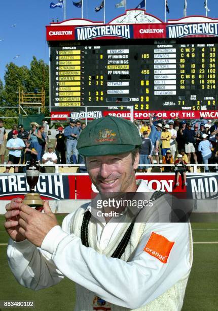 Victorious Australian captain Steve Waugh holds a replica of the Ashes urn in front of the scoreboard, after his sides win on day three of the third...