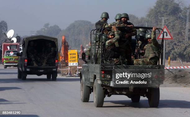 Pakistani army soldiers arrive at Peshawar Agricultural Training Institute which was attacked by Taliban militants, in the northwestern city of...