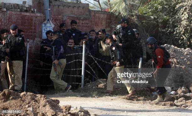 Pakistani security forces are seen outside Peshawar Agricultural Training Institute which was attacked by Taliban militants, in the northwestern city...