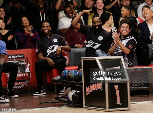 James Harden flexes his muscle as Chris Paul, left, and Oscar Nunez look on as they attend the State Farm Chris Paul PBA Celebrity Invitational at...