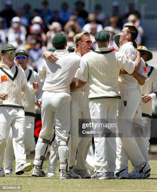 Glenn McGrath of Australia and teammate Brett Lee , congratulate each other after combining to run out England batsman Michael Vaughan for 9 runs, on...