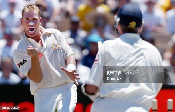 Australian spinner Shane Warne gives England batsman Andrew Caddick a send-off after bowling him around his legs on the second day of the second Test...