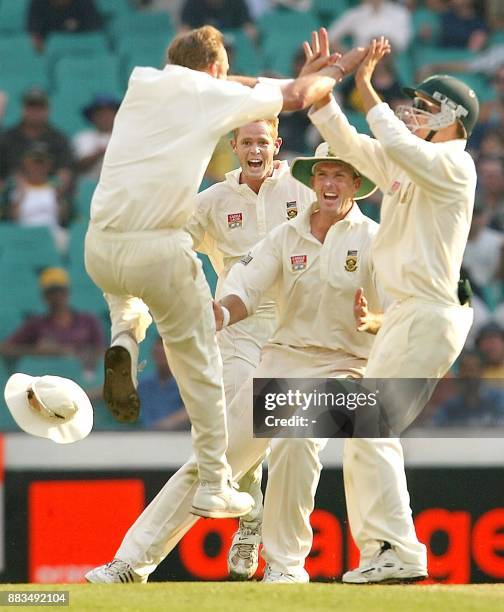 South African paceman Allan Donald celebrates with teammates Shaun Pollock , Claude Henderson and Boeta Dippenaar after dismissing Australian batsman...