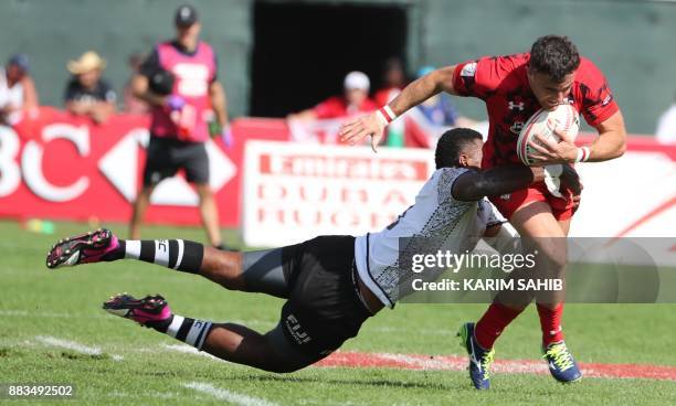 Kalione Nasoko of Fiji is tackled by Wales' Luke Morgan during a match between Fiji and Wales in the Men's Sevens World Rugby Dubai Series on...