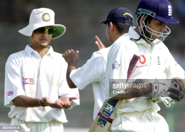 Board President's XI players Murali Karthik and Dinesh Mongia celebrate the wicket of England batsman Michael Vaughn on the first day of their three...