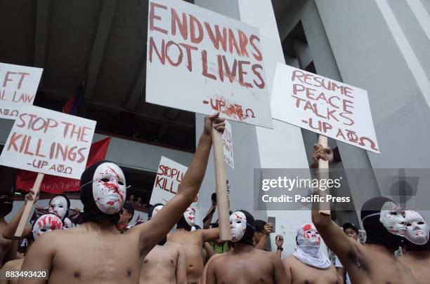 Members of the Alpha Phi Omega display placards as they run around naked in the Arts and Sciences building in the traditional "Oblation Run" to...