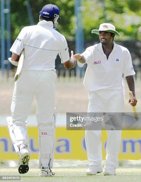 Indian batsman Venkatesh Prasad congratulates Sri Lankan spinner Muttiah Muralitharan after Sri Lanka beat India in the third and final Test match at...