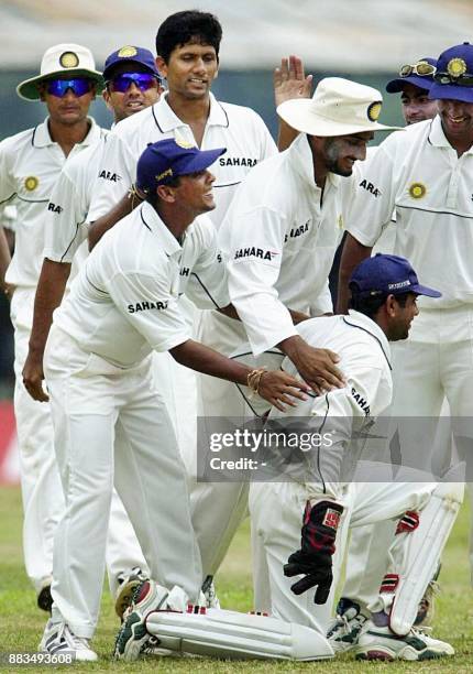 Indian players congratulate wicket keeper Samir Dighe after he took a catch off the bowling of pace bowler Venkatesh Prasad to dismiss Sri Lankan...