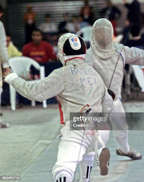 Fencing athletes Salvador Ramírez and Carlos Salmerón, are seen in action 03 December 2002. El esgrimista mexicano Salvador Ramírez , ataca al...
