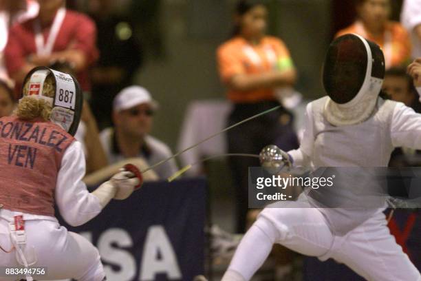 Athletes Mariana Gonzalez and Melissa Alvarenga are seen in action during the fencing competition in San Salvador, El Salvador 03 December 2002. El...