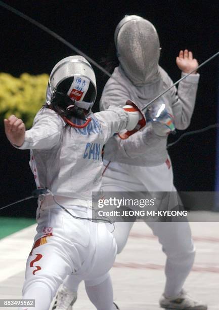 Chinese fencer Huang Haiyang duels with Cho Kyung Mi of South Korea in the women sabre team at the14th Asian Games in Busan 03 October 2002. China...