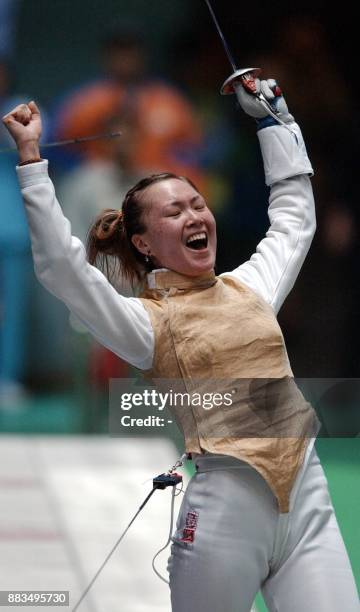 South Korean fencer Seo Mi Jung celebrates after defeating China's Zhang Lei in the women foil team event at the at the14th Asian Games in Busan, 03...