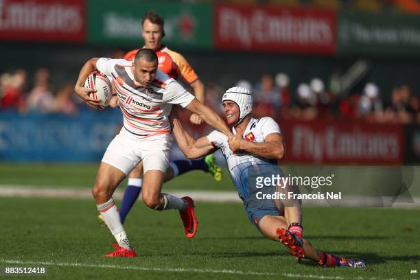 Tom Mitchell of England is tackled by Manoel Dall Igna of France during the match between England and France on Day Two of the Emirates Dubai Rugby...