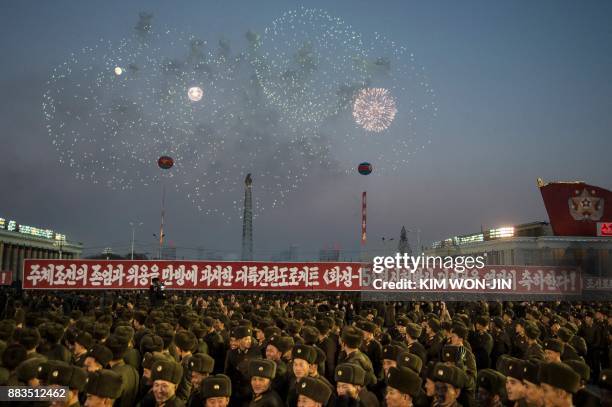 North Korean soldiers watch a fireworks display put on to celebrate the North's declaration on November 29 it had achieved full nuclear statehood,...
