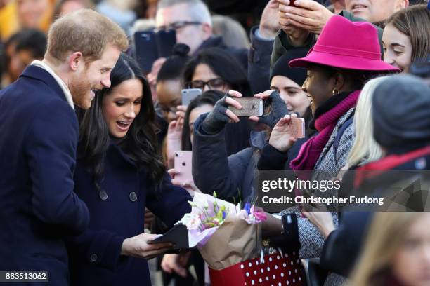 Prince Harry and Meghan Markle receive gifts from members of the public as they visit Nottingham Contemporary on December 1, 2017 in Nottingham,...