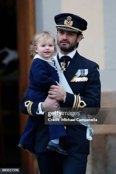 Prince Carl Philip holding Prince Alexander, Duke of Sodermanland attends the christening of Prince Gabriel of Sweden at Drottningholm Palace Chapel...