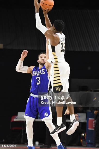 Bryant Crawford of the Wake Forest Demon Deacons takes a shot over Graham Woodward of the Drake Bulldogs during the quarterfinals of the Paradise Jam...