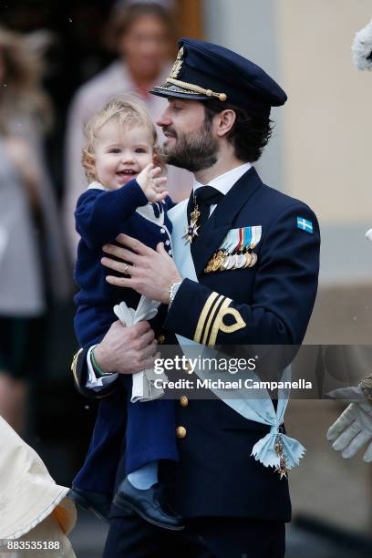 Prince Carl Philip holding Prince Alexander, Duke of Sodermanland leaves the chapel after the christening of Prince Gabriel of Sweden at...