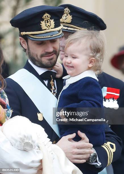 Prince Carl Philip holding Prince Alexander, Duke of Sodermanland leaves the chapel after the christening of Prince Gabriel of Sweden at...