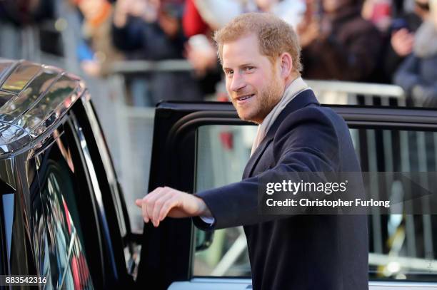 Prince Harry waves to the crowd as he departs Nottingham Contemporary alongside Meghan Markle on December 1, 2017 in Nottingham, England. Prince...