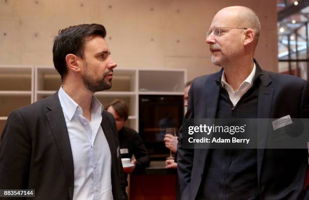 Felix Falk, head of the BIU , speaks to Oliver Castendyk, professor at the Hamburg Media School, as they attend a presentation of a BIU survey of the...