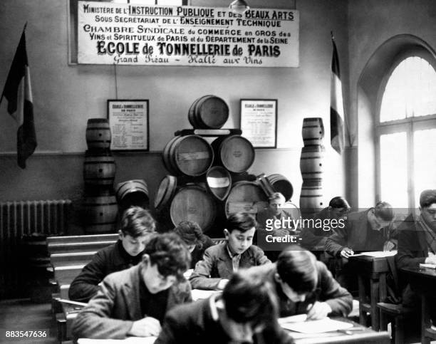 Pupils work in a classroom of the cooperage school, in 1949 at the wine market , in Paris.