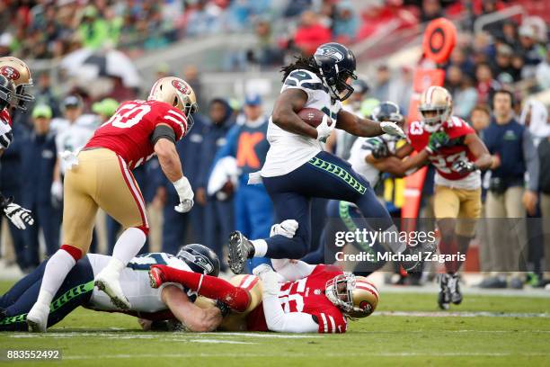 Reuben Foster of the San Francisco 49ers tackles Eddie Lacy of the Seattle Seahawks during the game at Levi's Stadium on November 26, 2017 in Santa...