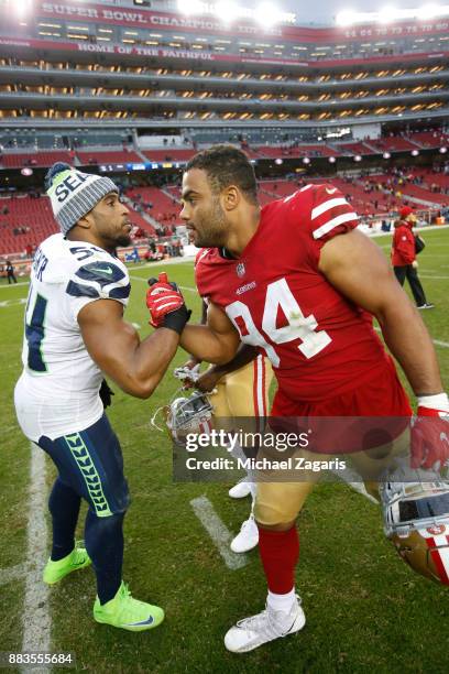 Bobby Wagner of the Seattle Seahawks and Solomon Thomas of the San Francisco 49ers talk on the field following the game at Levi's Stadium on November...