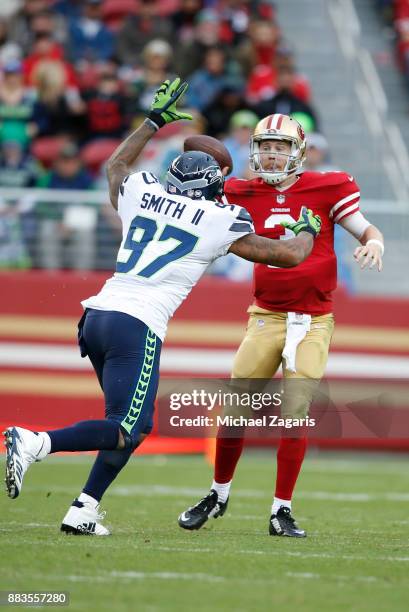 Beathard of the San Francisco 49ers passes under pressure during the game against the Seattle Seahawks at Levi's Stadium on November 26, 2017 in...